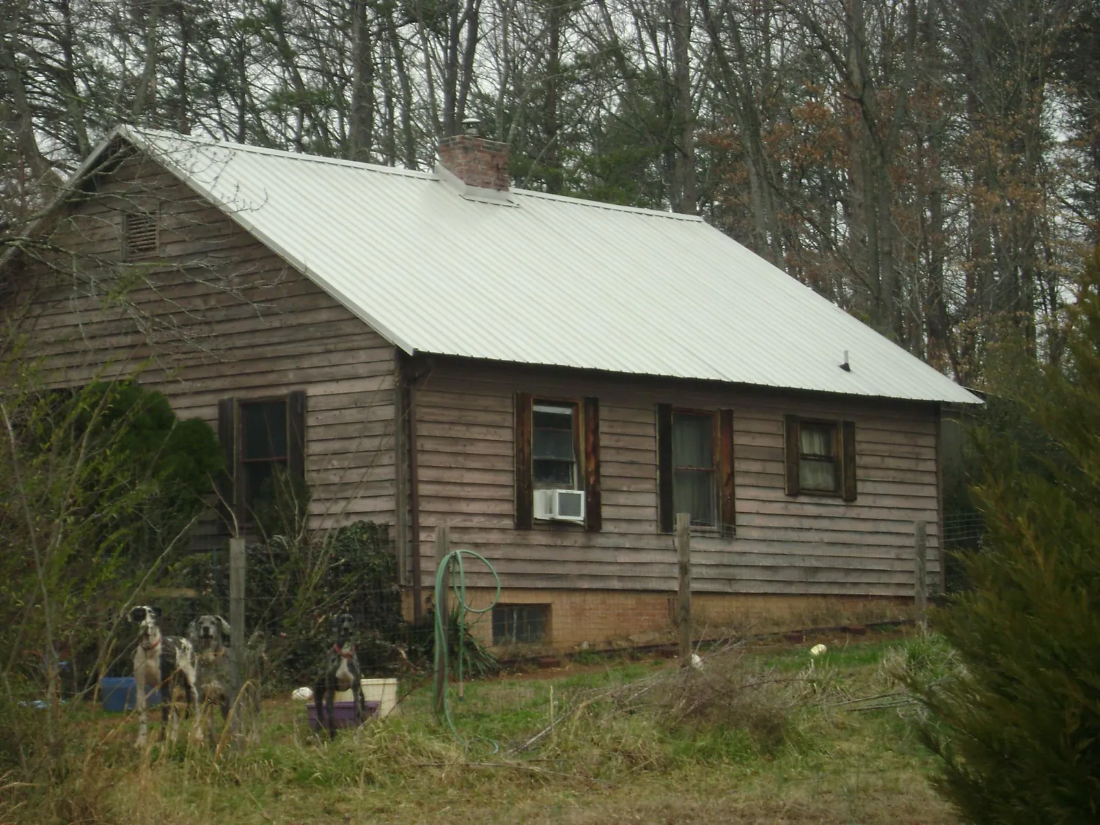 White metal roof on an old wood sided farmhouse, from a Metal Roof Installation job in River Edge